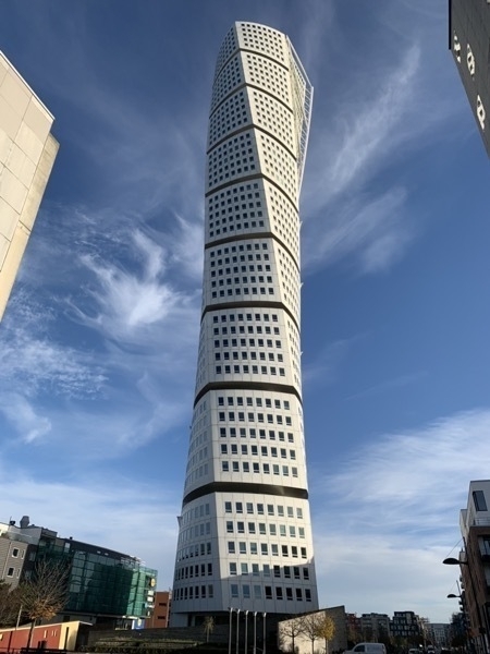 Malmö Turning Torso Tower on a sunny day with light clouds and blue sky
